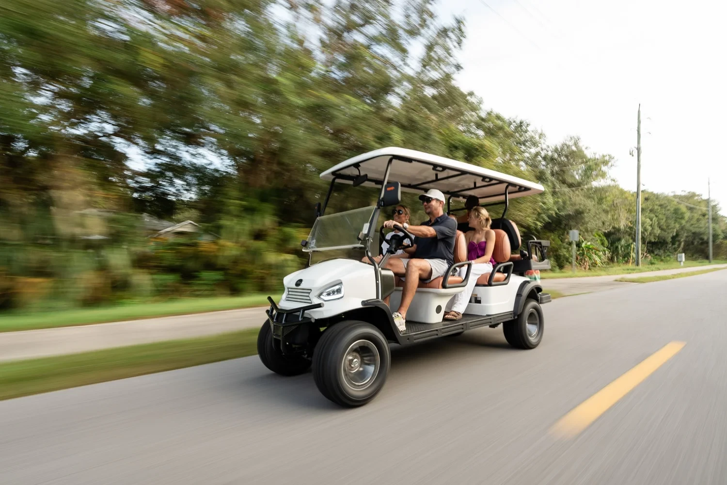 Man driving a golf cart on a sunny golf course